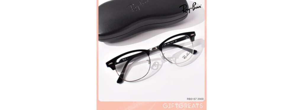 กรอบแว่นสายตา Ray-Ban RB5157 ทรงเส้นคิ้ว ขอบบนสีดำ วงเลนส์โลหะสีเงิน วางคู่กล่องแว่น